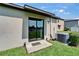 Home's back door opens to a patio and the home's air conditioning unit at 11121 Hudson Hills Ln, Riverview, FL 33579