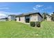 A well-maintained backyard with green grass and view of the rear of the home at 11121 Hudson Hills Ln, Riverview, FL 33579