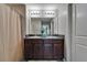 Bright bathroom featuring dual sinks, granite countertops, and a shower with curtain at 11121 Hudson Hills Ln, Riverview, FL 33579
