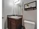 A well lit bathroom featuring granite counters, vanity with a mirror, and toilet at 11121 Hudson Hills Ln, Riverview, FL 33579