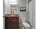 Neutral bathroom featuring a vanity with granite counters and a shower with a striped shower curtain at 11121 Hudson Hills Ln, Riverview, FL 33579