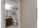 Neutral bathroom featuring a vanity with granite counters and a shower with a striped shower curtain at 11121 Hudson Hills Ln, Riverview, FL 33579