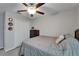 Bedroom with a ceiling fan, double door closet, and grey bedding at 11121 Hudson Hills Ln, Riverview, FL 33579