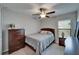 Bedroom with a ceiling fan, natural light and wood furniture at 11121 Hudson Hills Ln, Riverview, FL 33579