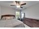 A bedroom featuring a queen size bed, dresser, and neutral tones at 11121 Hudson Hills Ln, Riverview, FL 33579