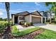 Charming single-story home featuring lush lawn, landscaped beds and a convenient two-car garage at 11121 Hudson Hills Ln, Riverview, FL 33579