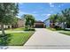 Attractive single-Gathering house featuring a well-kept lawn, mature trees, and attached two-car garage at 11121 Hudson Hills Ln, Riverview, FL 33579