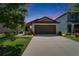Charming single-story home with a well-manicured lawn, a large driveway and inviting curb appeal at twilight at 11121 Hudson Hills Ln, Riverview, FL 33579