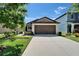Charming single-story home with a well-manicured lawn, a large driveway and inviting curb appeal at 11121 Hudson Hills Ln, Riverview, FL 33579