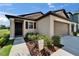 Home features a welcoming entryway with meticulous landscaping beds and a convenient two-car garage at 11121 Hudson Hills Ln, Riverview, FL 33579