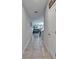 Hallway with tiled floors leading into the dining area, living room, and kitchen beyond at 11121 Hudson Hills Ln, Riverview, FL 33579