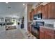Kitchen featuring an island, granite countertops, wooden cabinets, stainless steel appliances and dining area view at 11121 Hudson Hills Ln, Riverview, FL 33579