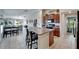 Open kitchen with central island, granite countertops, wooden cabinets, and modern appliances at 11121 Hudson Hills Ln, Riverview, FL 33579