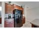 Kitchen featuring stainless steel appliances, brown cabinets, granite countertops, and tile flooring at 11121 Hudson Hills Ln, Riverview, FL 33579