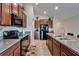 Kitchen featuring an island, granite countertops, wooden cabinets, stainless steel appliances, and an eating area at 11121 Hudson Hills Ln, Riverview, FL 33579