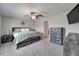 Spacious main bedroom with a ceiling fan, dresser, and light gray carpet at 11121 Hudson Hills Ln, Riverview, FL 33579