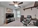 Office with black rolling chair, TV, and floating shelves at 11121 Hudson Hills Ln, Riverview, FL 33579