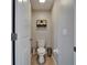 A half bathroom with tile flooring, a decorative shelf, and a toilet at 11121 Hudson Hills Ln, Riverview, FL 33579