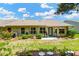 Inviting backyard with patio, landscaped garden, and well-maintained lawn for outdoor enjoyment at 11148 Hollander Ave, Hudson, FL 34667
