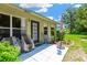 Enjoy the backyard patio with a table and chairs surrounded by lush landscaping and sunny skies at 11148 Hollander Ave, Hudson, FL 34667