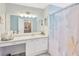 Well-lit bathroom featuring a large mirror, vanity, and a stylish shower curtain at 11148 Hollander Ave, Hudson, FL 34667