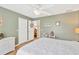 Charming bedroom with light green walls, wood floors, closet and a comfortable bed at 11148 Hollander Ave, Hudson, FL 34667