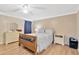 Comfortable bedroom with a wooden bed frame, neutral walls, and ample natural light at 11148 Hollander Ave, Hudson, FL 34667