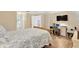 Bright bedroom setup featuring a full workstation with a desk, chair, and comfortable bed at 11148 Hollander Ave, Hudson, FL 34667