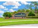 Community entrance sign amidst lush landscaping, welcoming residents to Heritage Pines at 11148 Hollander Ave, Hudson, FL 34667