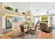 Inviting dining area with a glass-top table and views into the modern kitchen and living spaces at 11148 Hollander Ave, Hudson, FL 34667