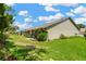 Beautiful backyard with a well-manicured lawn, patio area, and vibrant landscaping and nearby homes at 11148 Hollander Ave, Hudson, FL 34667