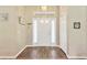 Bright entryway with hardwood floors, a stylish light fixture, and a classic white front door at 11148 Hollander Ave, Hudson, FL 34667