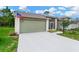 Inviting home showcasing a well-maintained lawn and a clean, modern driveway at 11148 Hollander Ave, Hudson, FL 34667