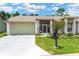Charming single-story home featuring a well-manicured lawn and inviting front entrance at 11148 Hollander Ave, Hudson, FL 34667