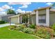 Landscaped front yard with colorful flowers enhancing the curb appeal of the home at 11148 Hollander Ave, Hudson, FL 34667