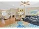 Bright living room boasts hardwood floors, vaulted ceilings, and a ceiling fan for maximum comfort at 11148 Hollander Ave, Hudson, FL 34667