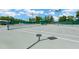 Community tennis courts are spacious with well-kept nets and lighting for evening games at 11148 Hollander Ave, Hudson, FL 34667