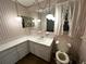 Bathroom featuring a toilet and vanity with decorative wallpaper at 11198 58Th Ave, Seminole, FL 33772