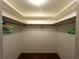 Walk-in closet with shelves and rod for optimal storage and organization at 11198 58Th Ave, Seminole, FL 33772