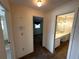 Hallway leading to bathroom and bedroom with wall thermostat at 11198 58Th Ave, Seminole, FL 33772