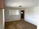 Simple living room with carpet, painted walls, and a window at 11198 58Th Ave, Seminole, FL 33772
