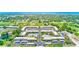 A beautiful aerial view of a condo community featuring a golf course, pool, and tennis court at 12300 Vonn Rd # 7107, Largo, FL 33774