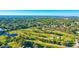 Expansive aerial view showcasing lush landscape with a golf course and waterway leading to the ocean beyond at 12300 Vonn Rd # 7107, Largo, FL 33774