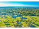 Stunning aerial view of golf course community near the ocean and a large, treed area at 12300 Vonn Rd # 7107, Largo, FL 33774