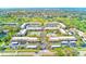 Beautiful aerial view of condo community, golf course, pool, tennis court and lush landscaping at 12300 Vonn Rd # 7107, Largo, FL 33774