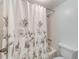 Bright bathroom with a floral shower curtain over the tub at 12300 Vonn Rd # 7107, Largo, FL 33774