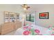 Charming bedroom with tiled floors, framed art and plenty of natural light at 12300 Vonn Rd # 7107, Largo, FL 33774