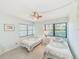 Inviting bedroom with twin beds, tiled flooring, and natural light at 12300 Vonn Rd # 7107, Largo, FL 33774