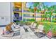 Outdoor common area with comfortable seating, a table, and lush landscaping for residents' relaxation and socialization at 12300 Vonn Rd # 7107, Largo, FL 33774