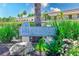 The Villas de Golf community sign is surrounded by lush landscaping and mature trees at 12300 Vonn Rd # 7107, Largo, FL 33774